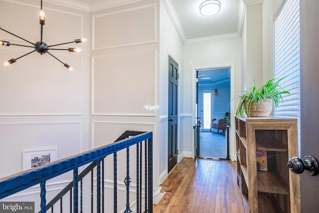 hallway featuring hardwood / wood-style flooring and crown molding