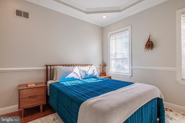 bedroom featuring ornamental molding and wood-type flooring