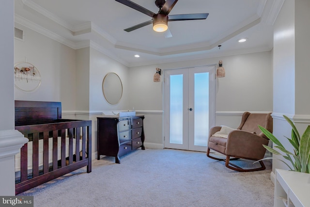 bedroom featuring french doors, light colored carpet, crown molding, and a tray ceiling