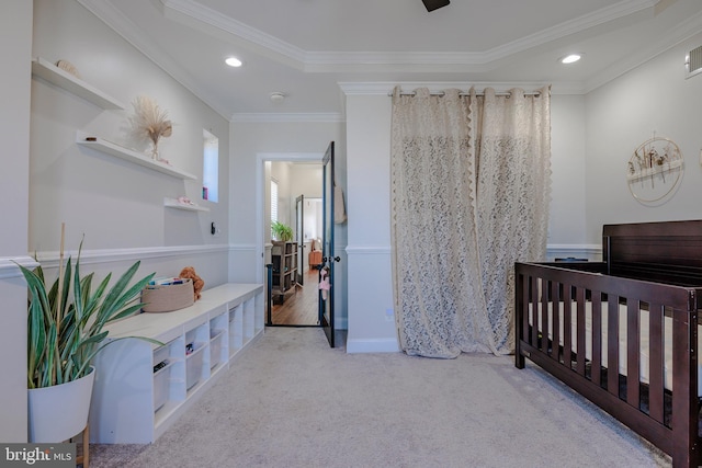 carpeted bedroom featuring a crib and ornamental molding