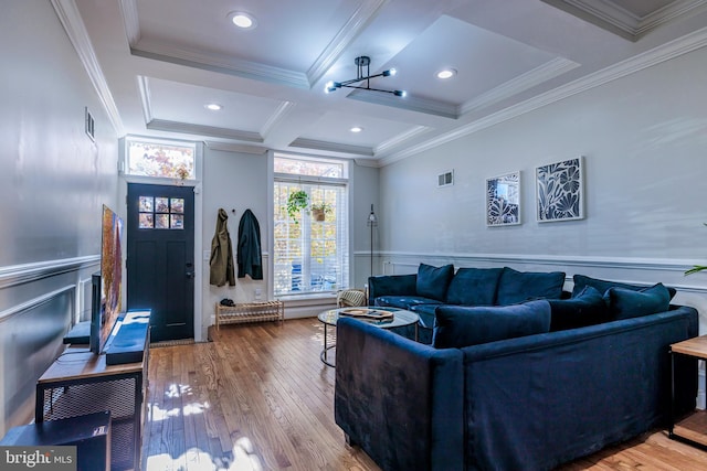 living room featuring ornamental molding, beam ceiling, an inviting chandelier, hardwood / wood-style floors, and coffered ceiling