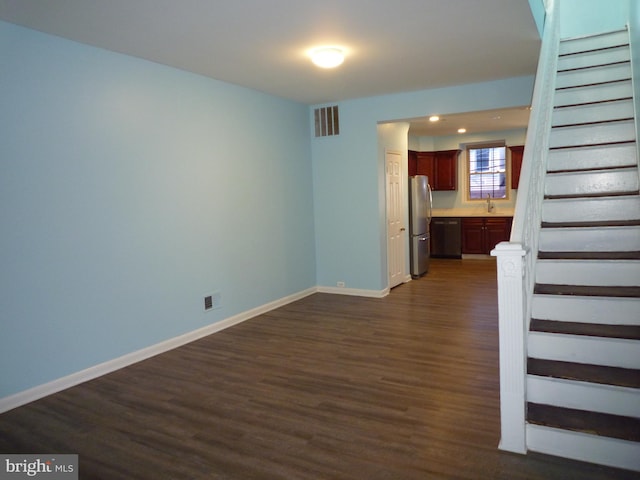 unfurnished living room with dark hardwood / wood-style flooring