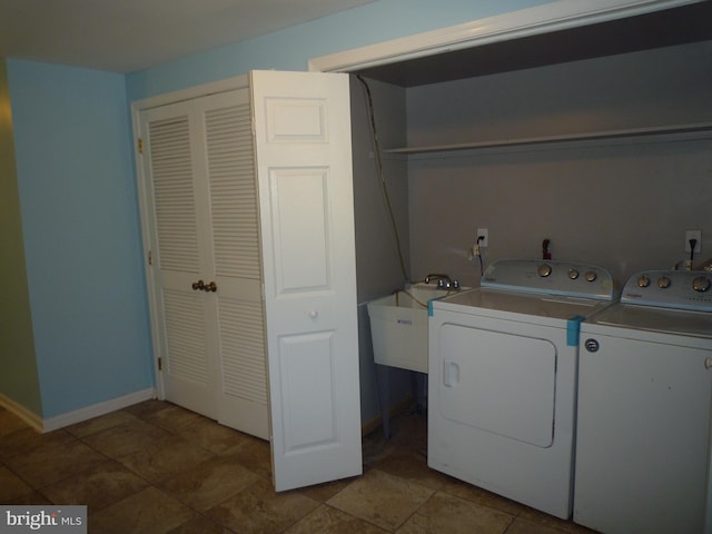 clothes washing area featuring sink, washer and clothes dryer, and tile patterned flooring