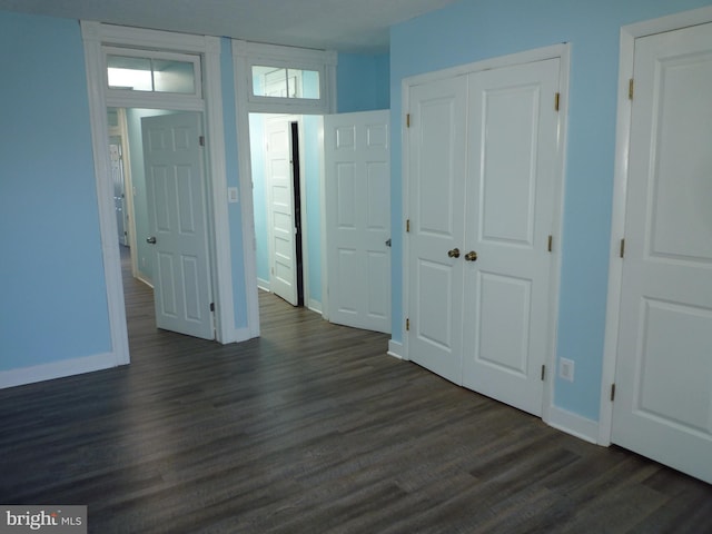 unfurnished bedroom with dark hardwood / wood-style flooring