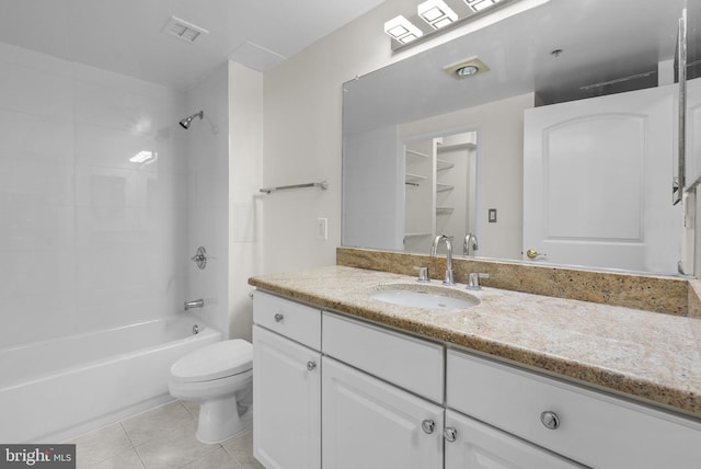 full bathroom featuring tiled shower / bath, vanity, toilet, and tile patterned floors