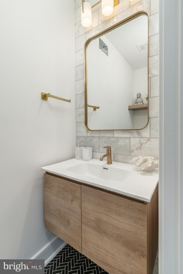 bathroom featuring vanity and tasteful backsplash