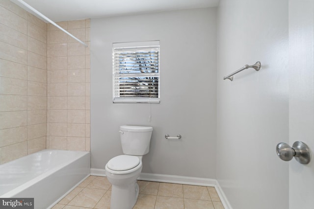 bathroom with tile patterned flooring, tiled shower / bath combo, and toilet