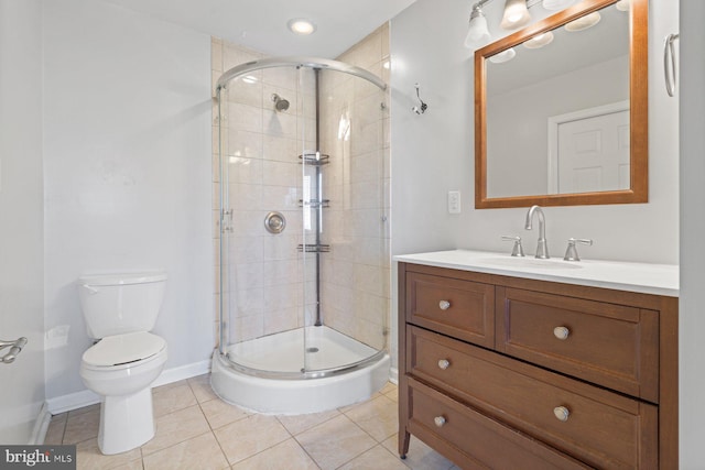 bathroom with tile patterned floors, vanity, toilet, and a shower with door