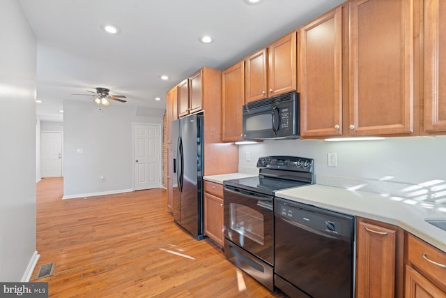 kitchen with ceiling fan, black appliances, and light wood-type flooring