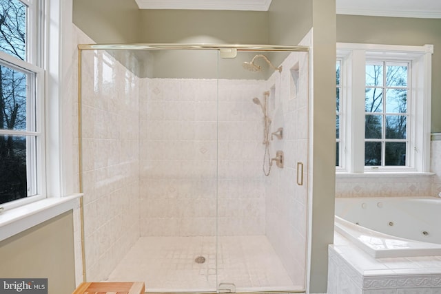 full bath featuring ornamental molding, a shower stall, and a whirlpool tub