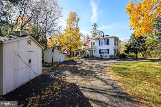 exterior space with a shed and a front yard