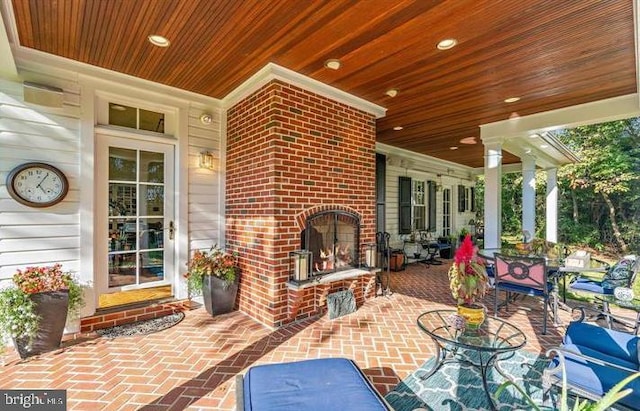 view of patio / terrace with an outdoor brick fireplace