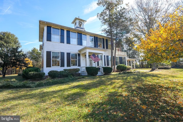 colonial-style house with a front lawn