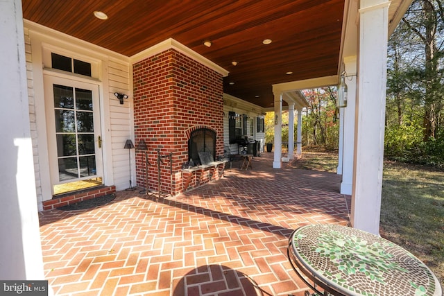 view of patio / terrace with an outdoor brick fireplace