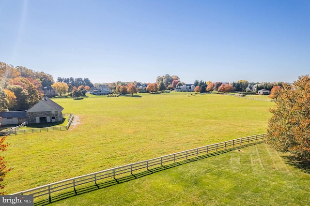 view of yard featuring a rural view and fence