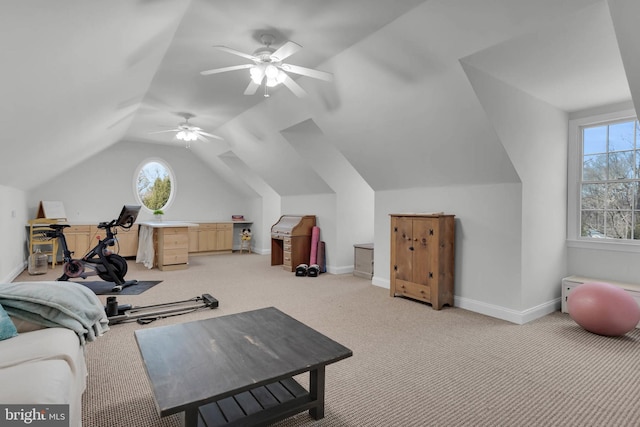 exercise room featuring vaulted ceiling, carpet, a ceiling fan, and baseboards