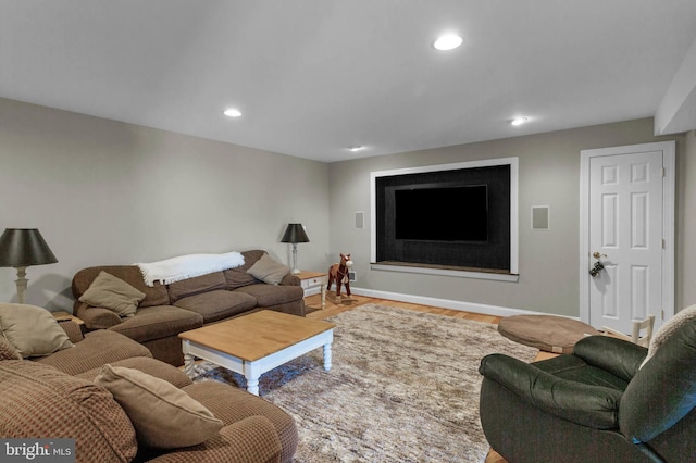 living area featuring recessed lighting, baseboards, and wood finished floors