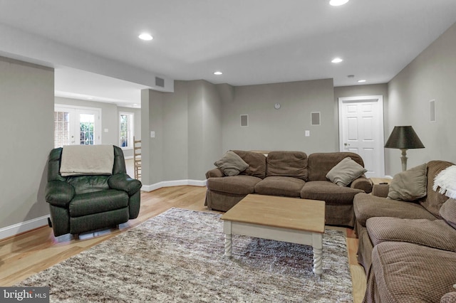 living room featuring light wood finished floors, baseboards, visible vents, and recessed lighting