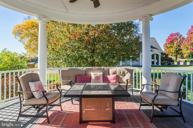 deck featuring ceiling fan and an outdoor living space