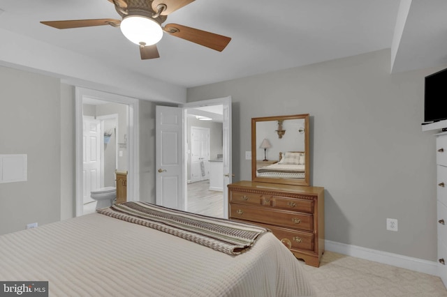 bedroom with connected bathroom, a ceiling fan, and baseboards