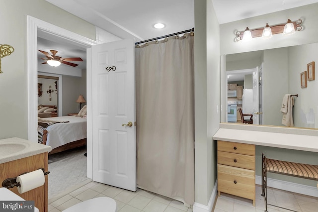 ensuite bathroom featuring vanity, tile patterned flooring, connected bathroom, and a ceiling fan