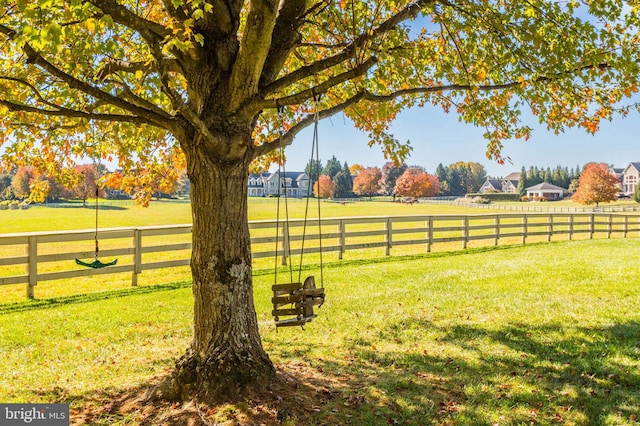 view of yard featuring a rural view and fence