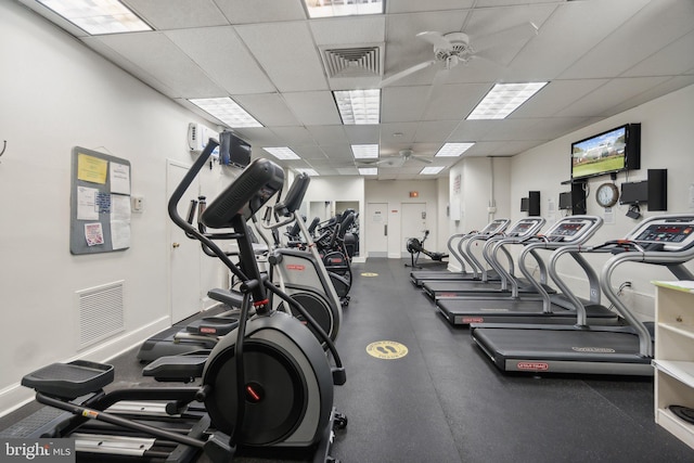 exercise room featuring a paneled ceiling and ceiling fan