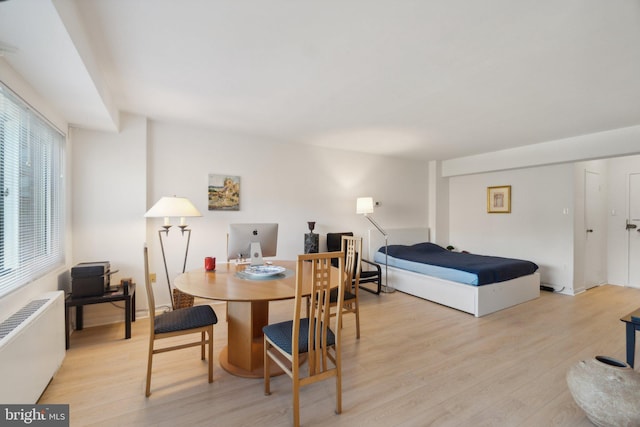 dining room featuring light hardwood / wood-style flooring and radiator heating unit