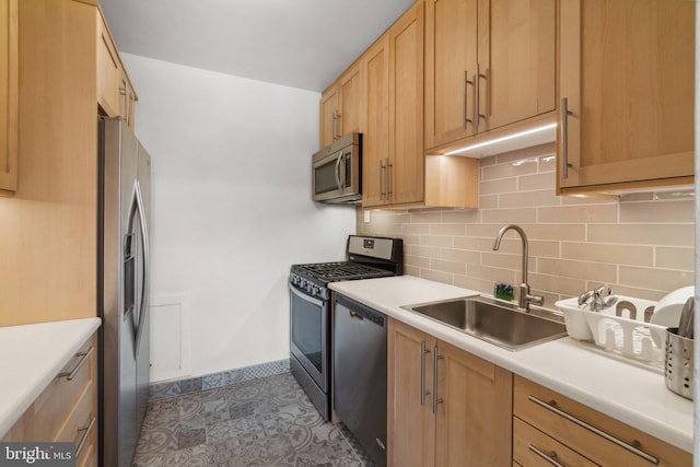 kitchen featuring decorative backsplash, stainless steel appliances, sink, and light brown cabinetry