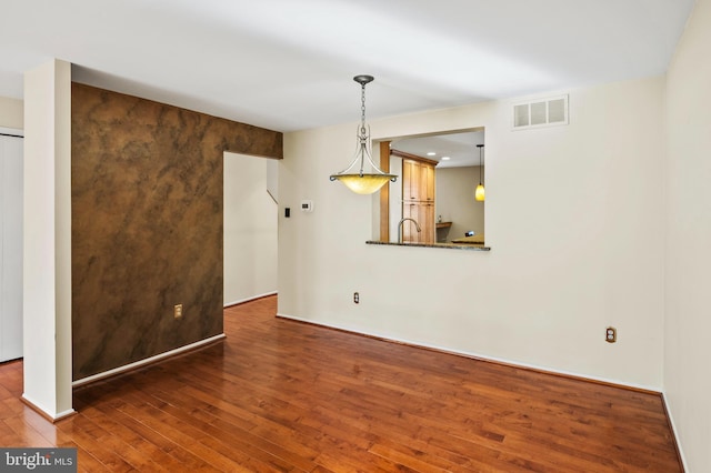 empty room with dark wood-type flooring