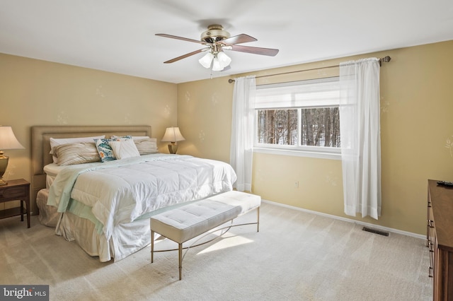 bedroom featuring ceiling fan and light carpet