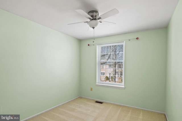 unfurnished room with light carpet and ceiling fan