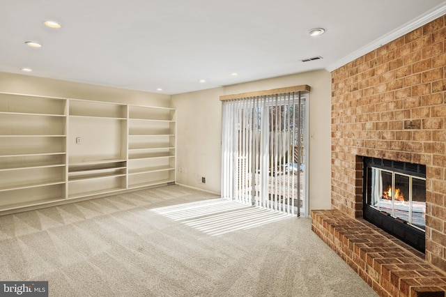 unfurnished living room with carpet and a brick fireplace