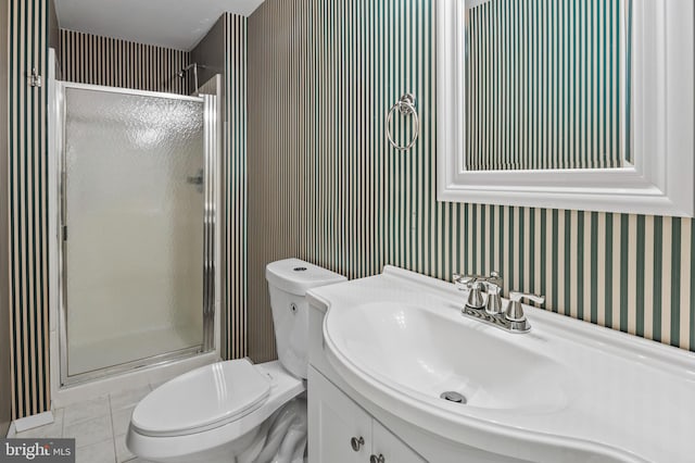 bathroom featuring vanity, an enclosed shower, tile patterned floors, and toilet