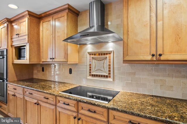 kitchen with dark stone countertops, black electric stovetop, tasteful backsplash, and wall chimney range hood