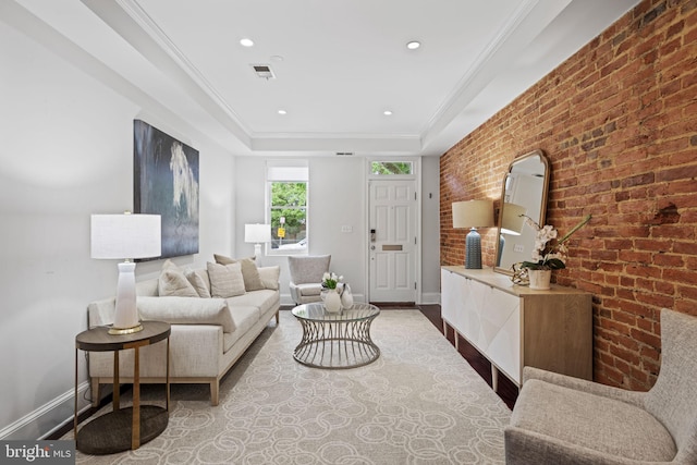 living room featuring brick wall, crown molding, and wood-type flooring