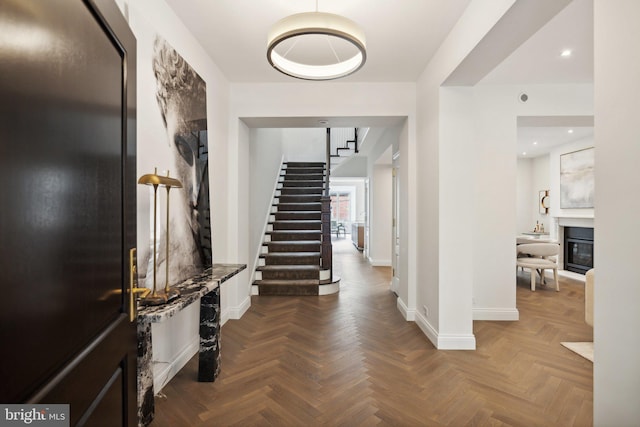 foyer entrance featuring parquet flooring