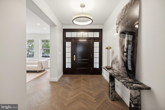 foyer with dark parquet floors