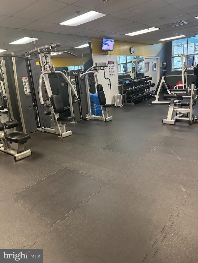 gym with a paneled ceiling