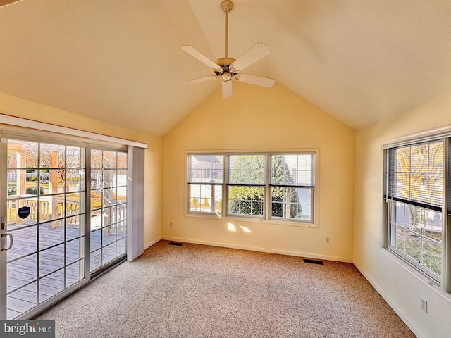 carpeted empty room featuring vaulted ceiling and ceiling fan