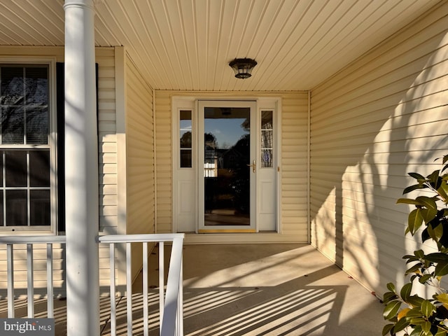 view of exterior entry with a porch