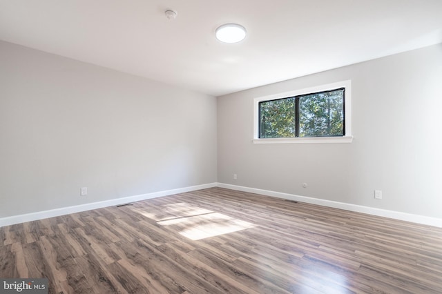 unfurnished room featuring hardwood / wood-style flooring