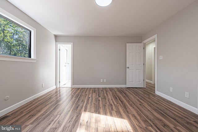 empty room with dark wood-type flooring