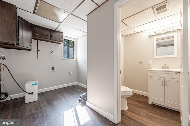 bathroom featuring vanity, a paneled ceiling, wood-type flooring, and toilet