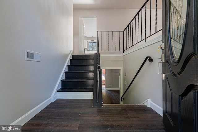 stairway featuring wood-type flooring