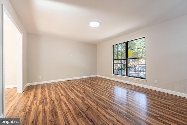 spare room featuring wood-type flooring