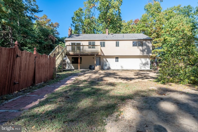 back of property featuring a wooden deck