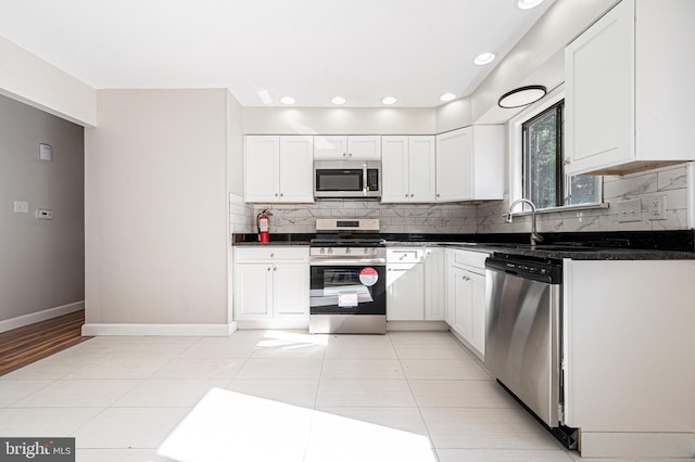 kitchen featuring white cabinetry, stainless steel appliances, and tasteful backsplash