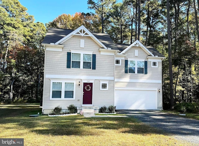 view of front facade with a garage and a front yard