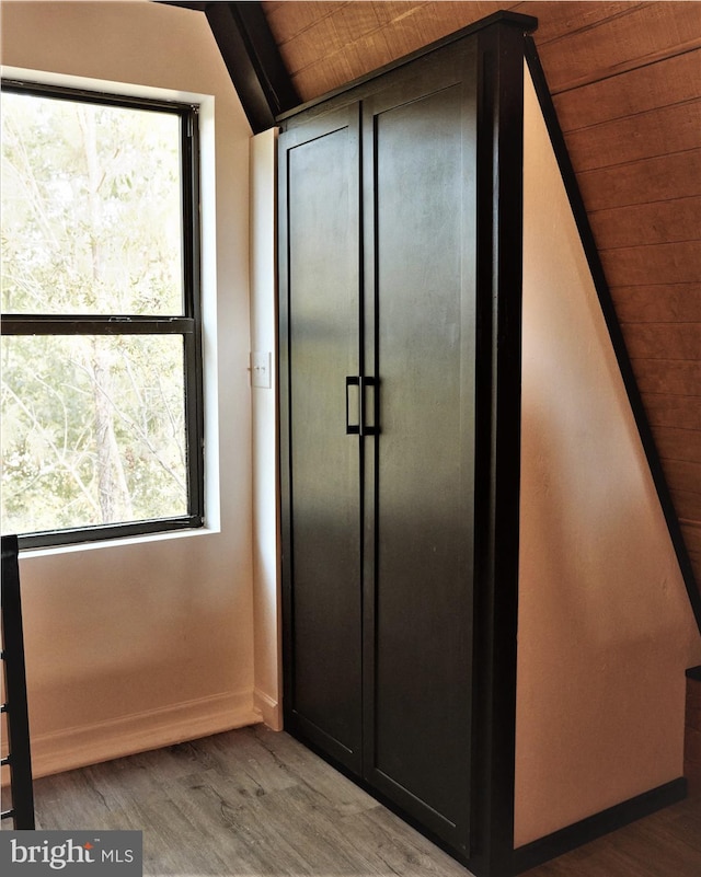 interior space featuring hardwood / wood-style floors and wood ceiling